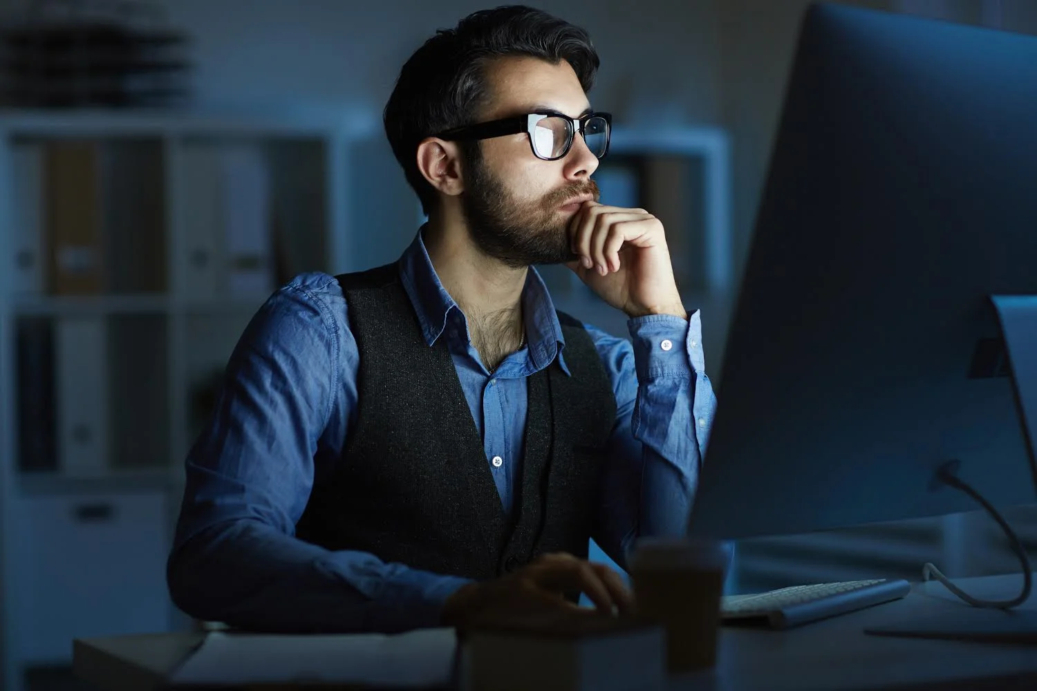 Diseño web: hombre sentado viendo un computador.